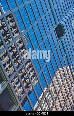 Two buildings reflected on nearby skyscraper Stock Photo