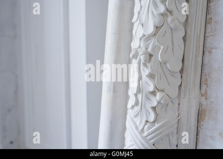 Beautiful elements of luxury wall design, white stucco mouldings over light background, antique plastering Stock Photo