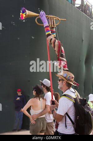 A spectator carrying his hand-made Jazz Fest totem at the New Orleans' Jazz & Heritage festival. Stock Photo