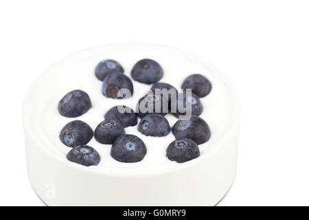 Blueberries sprinkled on bowl of Greek yogurt Stock Photo