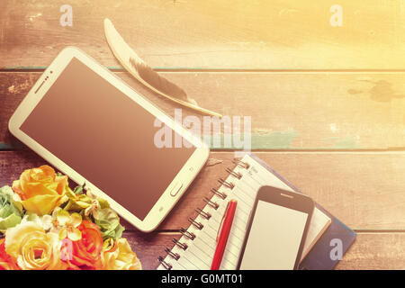 Tablets and notebooks on the old wooden Stock Photo
