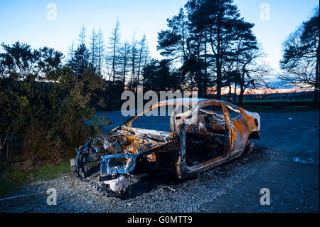 Burned-out car at remote location in Forest of Bowland Lancashire Stock Photo