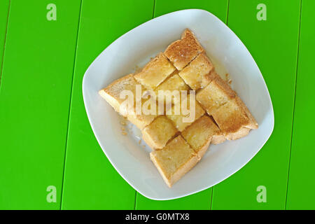 slice toast with butter sweetened condensed milk and sugar on top Stock Photo