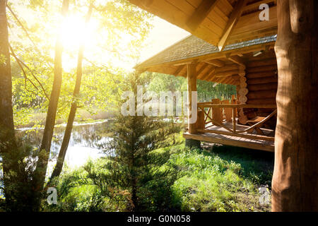 Wooden house and pond at the sunrise Stock Photo