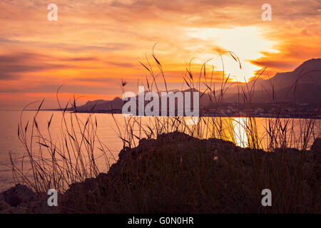 Image of colorful sunset landscape on Crete, Greece. The village of Mkrigialos in the background. Stock Photo