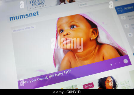 Pages on the Mumsnet website displayed on the screen of a tablet. Stock Photo