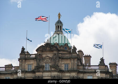 Top part of the Bank Of Scotland building with Saltire and Union Jack flags -  Edinburgh, Scotland Stock Photo