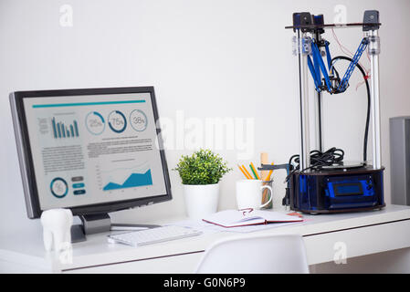 printer standing near computer Stock Photo