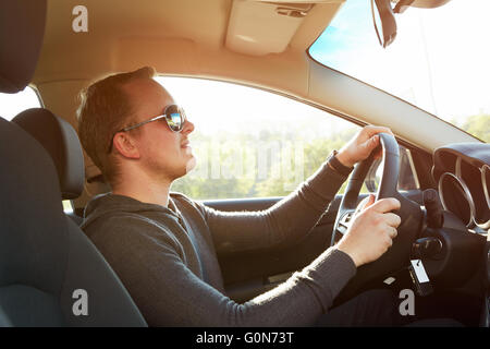 Handsome man driving car wearing  sunglasses Stock Photo