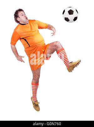 recreational fat football player kicking the ball isolated on a white background Stock Photo