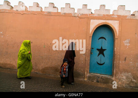 Two women and a boy walking in the streets of Tiznit Stock Photo