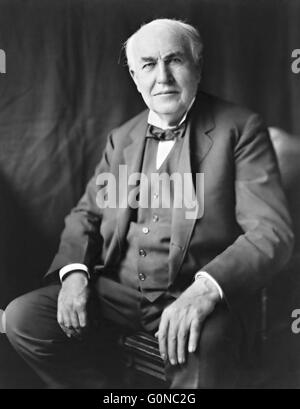 Inventor Thomas Alva Edison, three-quarter length portrait, seated, facing front from 1922. Edison developed or invented the photography, motion picture camera, electric light bulb, sound recording, stock ticker and dozens of other devices. Stock Photo