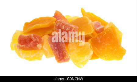 A serving of pineapple, mango and papaya sugared dried fruit isolated on a white background. Stock Photo