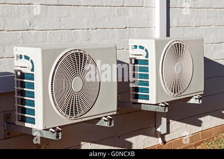 Two newly installed air conditioning units mounted on wall Stock Photo