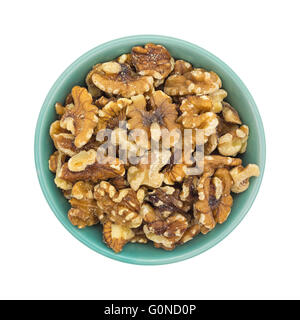 Top view of a bowl filled with shelled walnuts isolated on a white background. Stock Photo