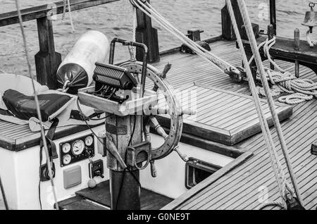 Steering wheel and deck of the old boat Stock Photo