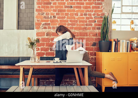 Portrait of man and woman embracing each other at a cafe, couple meeting in a coffee shop. Stock Photo