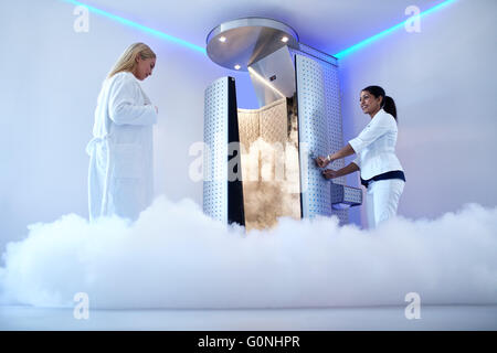 Portrait of woman going for cryotherapy treatment in cryosauna booth. Stock Photo