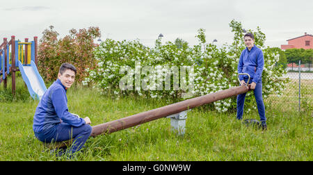 multiplicity photo, boy plays with himself on a seesaw Stock Photo