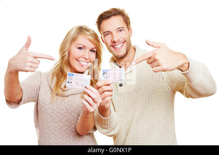 Two happy teenager showing proudly their German drivers licence Stock Photo