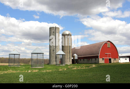 Wisconsin dairy farm with red barn, tall storage silo and green fields ...
