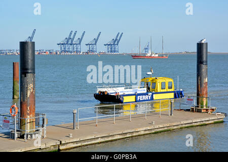 Harwich Shotley Felixstowe ferry at Shotley Marina with coastal container port cranes beyond in the Rivers Orwell & Stour estuary Stock Photo