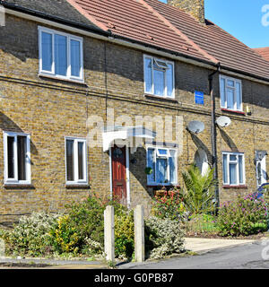 First block of brick built council houses completed by LCC on the East London Becontree housing estate 1921 as recorded on blue plaque on this home UK Stock Photo