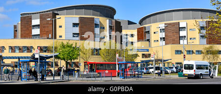 Bus stops at Queens General Hospital Romford includes sign for the Maternity Unit entrance to ward in the East London Borough of Havering England UK Stock Photo