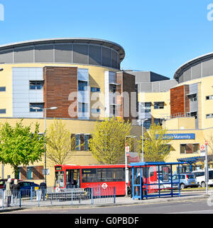 Bus stops at Queens General Hospital Romford includes sign for the Maternity Unit entrance to ward in the East London Borough of Havering England UK Stock Photo