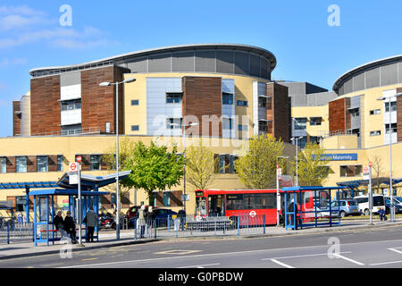 Bus stops at Queens General Hospital Romford includes sign for the Maternity Unit entrance to ward in the East London Borough of Havering England UK Stock Photo