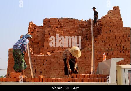Yangon, Myanmar. 3rd May, 2016. Laborers work at a brick factory on the outskirts of Yangon, Myanmar, May 3, 2016. Myanmar has pledged to promote and protect labor rights, including ending forced labor and stronger enforcement of child labor law in the country, the Ministry of Labor, Immigration and Population said on Monday. Credit:  U Aung/Xinhua/Alamy Live News Stock Photo