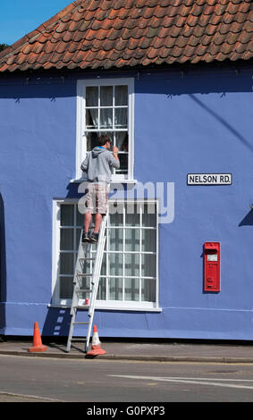 painter and decorator painting exterior of house Stock Photo