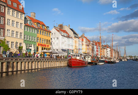 COPENHAGEN, DENMARK - AUGUST 25: unidentified people enjoying sunny weather in open cafees of the famous Nyhavn promenade on Aug Stock Photo