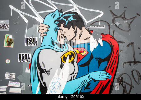 Batman kissing superman Stock Photo - Alamy