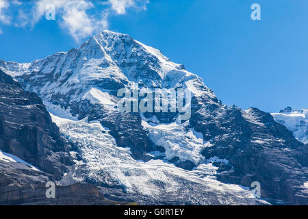 Close view of the famous peak Monch of the swiss Alps on Bernese Oberland in Switzerland. It is one of the main summits of the B Stock Photo