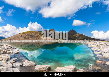 Stunning view of the Fallbodensee (lake) on Bernese Oberland with reflection of clouds and mountain ranges, Switzerland. Stock Photo