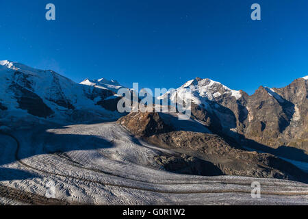 Night view of the Bernina massive and Morteratsch glacier in moon light from the mountain house of Diavolezza, in Engadine area  Stock Photo