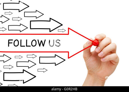 Hand drawing Follow Us arrows concept with marker on transparent wipe board. Stock Photo