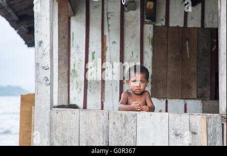 JAYAPURA, WEST PAPUA, INDONESIA - CIRCA FEBRUARY 2016: Small Papuan boy, looking scared Stock Photo