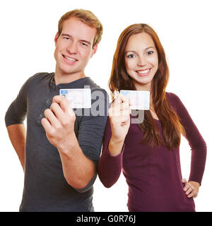 Two happy teenager showing their German drivers licence Stock Photo
