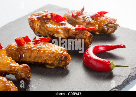 fried chicken wings on a black slate plate Stock Photo