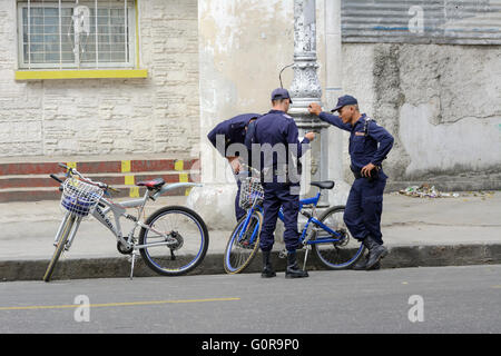 Three Cuban policemen on patrol with their bicycles in Havana, Cuba Stock Photo