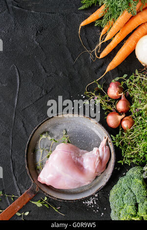 Raw rabbit legs with vegetables Stock Photo