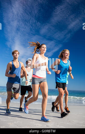 People jogging on the beach Stock Photo