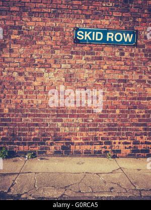 Skid Row Sign On A Red Brick Wall Stock Photo