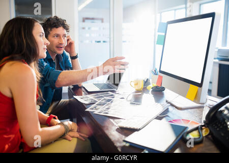 Two colleagues working at computer desk Stock Photo