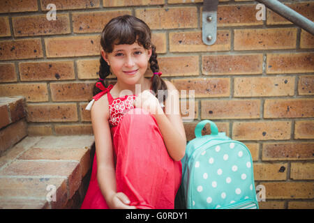 Brunette girl seated on stairs Stock Photo