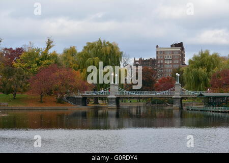 The Boston Public Garden on an Autumn day.  Pictured is the lagoon where the Swan boats carry thousands of guests each season. Stock Photo