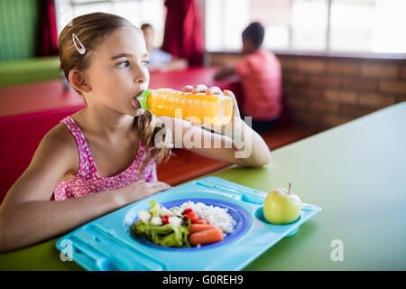 Child drinking at the canteen Stock Photo