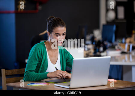 Close up view of attractive woman working at desk Stock Photo